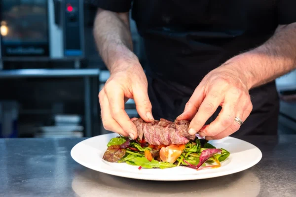 chef prepare local sourced produce pub lunch and dinner food at Brace of pheasants Inn Dorset UK